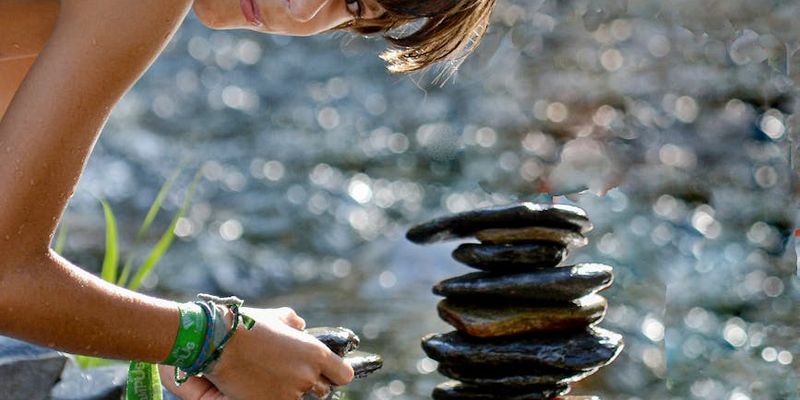 A perfectly balanced stack of stones on a dark background.